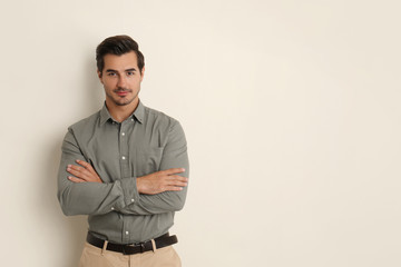Obraz premium Young male teacher on beige background. Space for text
