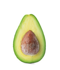Half of ripe avocado with pit on white background