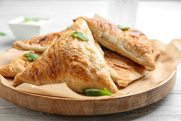 Fresh delicious puff pastry on white wooden table, closeup