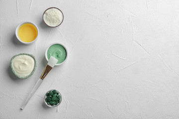 Flat lay composition with spirulina facial mask and ingredients on white table. Space for text