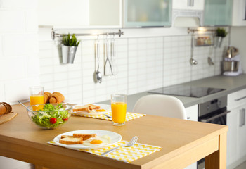 Tasty breakfast served on table in kitchen
