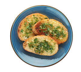 Slices of toasted bread with garlic and herb on white background, top view