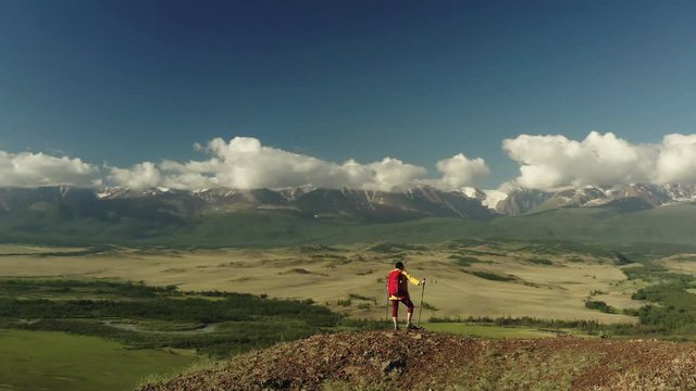 Aerial shot of woman hiker on top of mountain