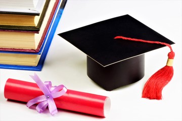 The concept of education is the student's graduation academic cap,globe,red diploma and books.Traditional graduation ceremony-in schools,colleges,University. The book is a source of knowledge.