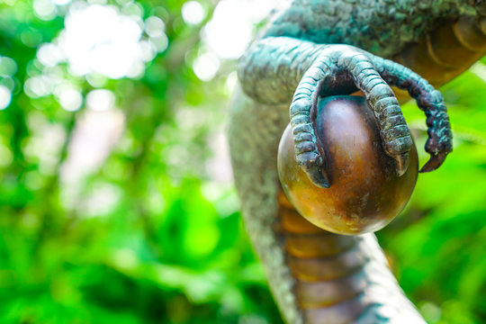 Vintage classic statue of Asian China Dragon sattle in the green garden.