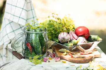 Harvest cucumbers. Fresh cucumbers in a glass jar, herbs and spices for pickling.