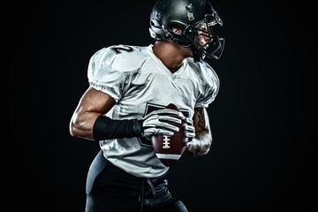 American football sportsman player in helmet on black background. Sport and motivation. Team sports.