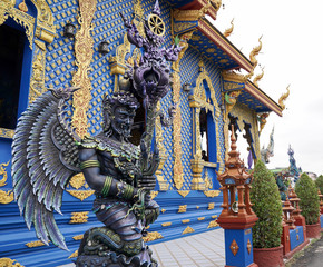 Fototapeta premium The Blue - Turquiose metalic God statue in Thai blue temple, at the North of Thailand.