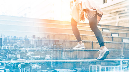 The double exposure image of the sporty woman running onsteps at early morning jogging  on city stairs.fitness, sport, people, exercising and lifestyle concept.Stretching outdoors.