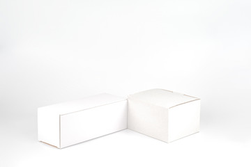 White two paper boxes - tall and fat lay on the white background in studio shot with clipping paht.