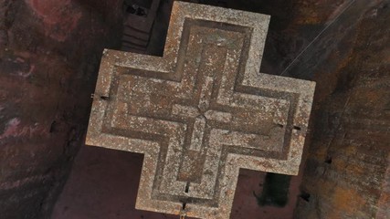Ascending rotating drone shot of amazing Church of Saint George in Lalibela, historic monument and important place of worship for Christian Orthodox religion in Ethiopia Africa
