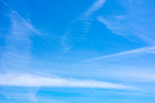 Blue Sky With Contrails And Wispy Clouds