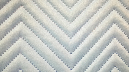 Knitted fabric with gray pattern. Abstract geometric textured zigzag background. Leather used as...