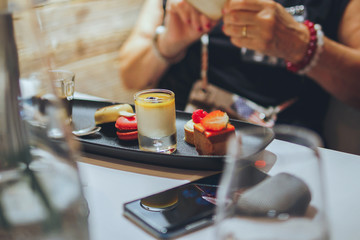 Mixed of small exquisite tastes of dessert on the black plate. Delicious snack. Pastry sweet dessert concept. Bakery design element. Restourant interior