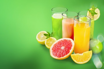 Tasty fruits  and juice with vitamins on background