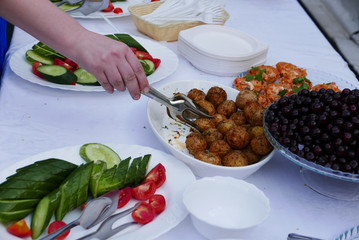 Hand gives a food on a table.