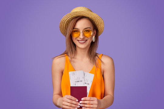Cheerful tourist with tickets and passport