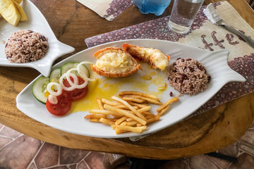 Lobster tail, rice and beans with a small salad and french fries