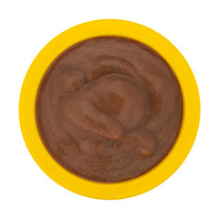 Blueberry and pear pureed fruit snack in a yellow bowl top view