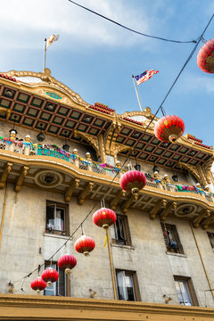 Low angle view of building decorated in lanterns