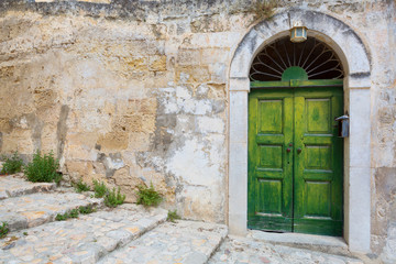 Fototapeta na wymiar green doors and old wall
