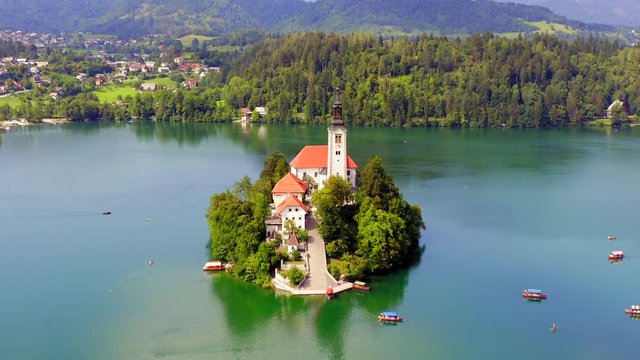 Lake Bled and the Church island of the assumption of Mary, Aerial footage on a beautiful Slovenian summer day.