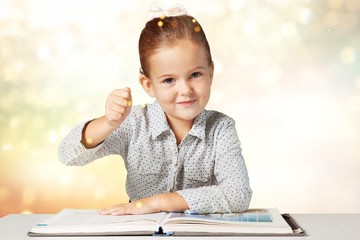 Adorable young girl reading a book
