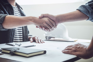 Obraz premium Finishing up a meeting, Two engineer or architect meeting for project, handshake after consultation and conference new project plan, contract for both companies, success, partnership