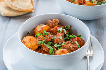 Aloo gosht with naan bread - lamb and potato curry - cuisine popular in Pakistan, Bangladesh and North India