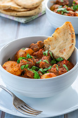 Aloo gosht with naan bread - lamb and potato curry - cuisine popular in Pakistan, Bangladesh and North India