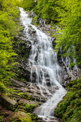 Obraz na płótnie Canvas Long exposure of powerful Piljski waterfall cascading down the rocky cliff during spring on Old mountain