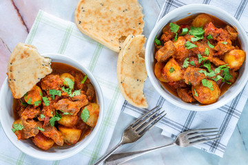 Aloo gosht with naan bread - lamb and potato curry - cuisine popular in Pakistan, Bangladesh and...