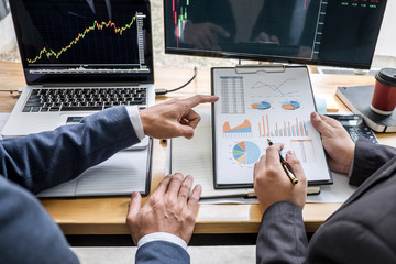Business team investment working with computer, planning and analyzing graph stock market trading with stock chart data, business financial investment and technology concept