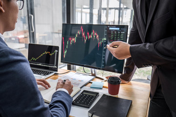 Business team partner working with computer, laptop, discussion and analyzing graph stock market trading with stock chart data planning, financial and investment concept