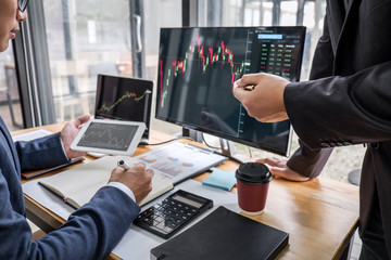 Business team partner working with computer, laptop, discussion and analyzing graph stock market trading with stock chart data planning, financial and investment concept