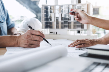 Construction and structure concept of Engineer or architect meeting for project working with partner and engineering tools on model building and blueprint in working site
