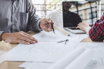 Construction and structure concept of Engineer or architect meeting for project working with partner and engineering tools on model building and blueprint in working site