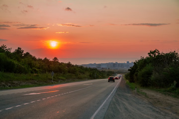 The road to the city against the setting sun.