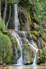 Fototapeta na wymiar Multiple silky water streams of waterfall Bigar on Old mountain in Serbia, near the city of Pirot and Kalna