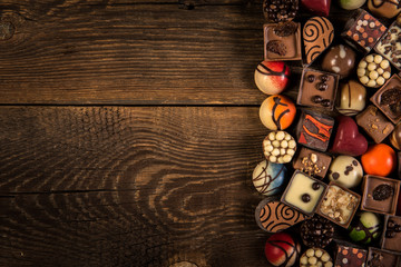 pralines on the wooden plank background