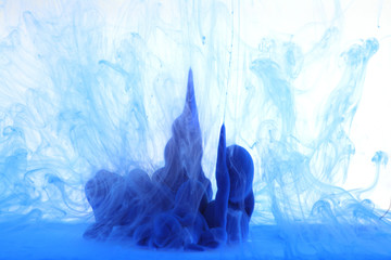 Abstract blue smoke on white background.  Acrylic colors in water. Ink blot.