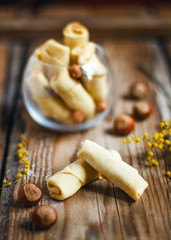 Traditional Azerbaijan holiday Nowruz cookies baklava on white plate on the rustic background with nuts and huzelnuts on green plate ,flat lay