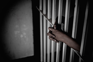 Hands of women desperate to catch the iron prison,prisoner concept,thailand people,Hope to be free,If the violate the law would be arrested and jailed.