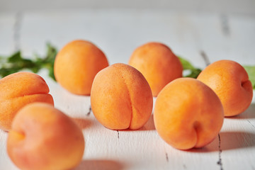 Apricots on white wooden background