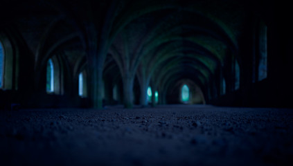 A dark and spooky background of arches in the dungeon of an old monastery, castle at night.