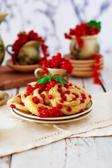 Cottage cheese cookie rolls with red currants on ceramic plate with vintage ceramic tea or coffee set,tea time,breakfast,summer sweets ,space for text