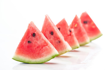 delicious juicy watermelon slices in row on white background