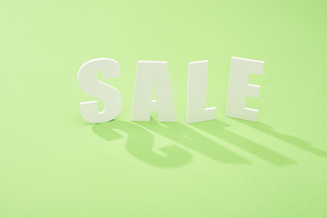 white sale lettering with shadow on green background