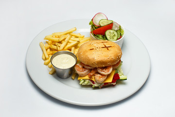 shrimp burger with caviar, vegetable salad and french fries, shrimp sauce