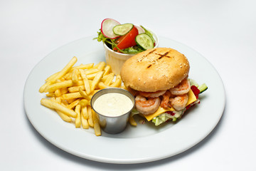 shrimp burger with caviar, vegetable salad and french fries, shrimp sauce